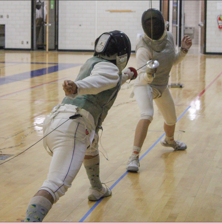 South Campus student Isaac Senisch and dual-credit student Persephone Battle practice a bout, a single fencing match.